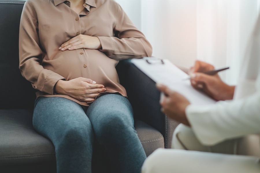 Pregnant woman at checkup discussing substance risks
