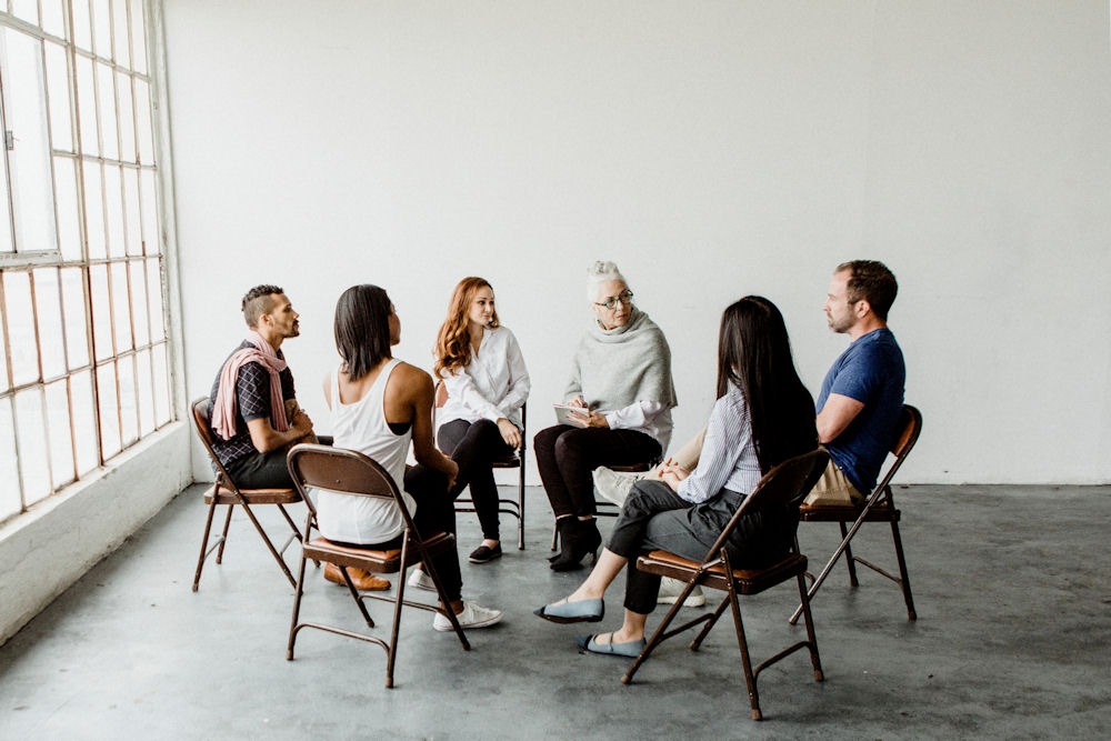 group of patients sitting in a circle during addiction therapy