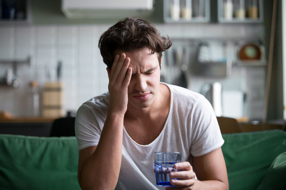 Man suffering from hangover anxiety