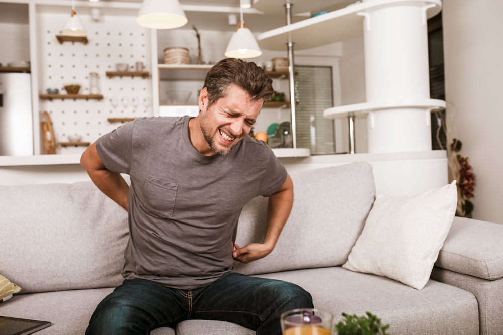 A man expressing discomfort due to kidney stones.