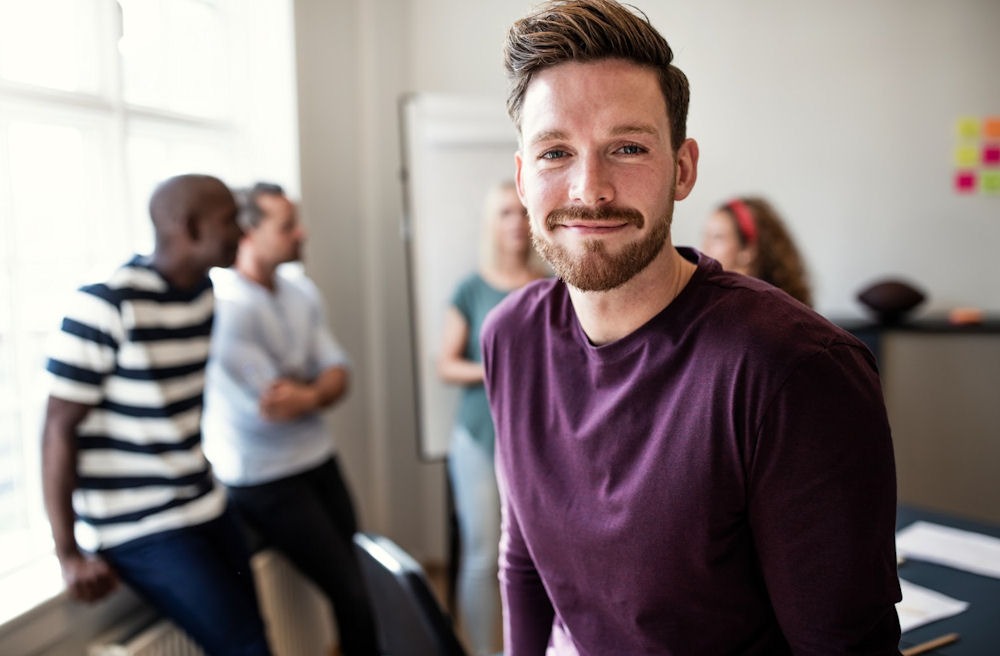 Confident young man in recovery group setting during residential treatment program