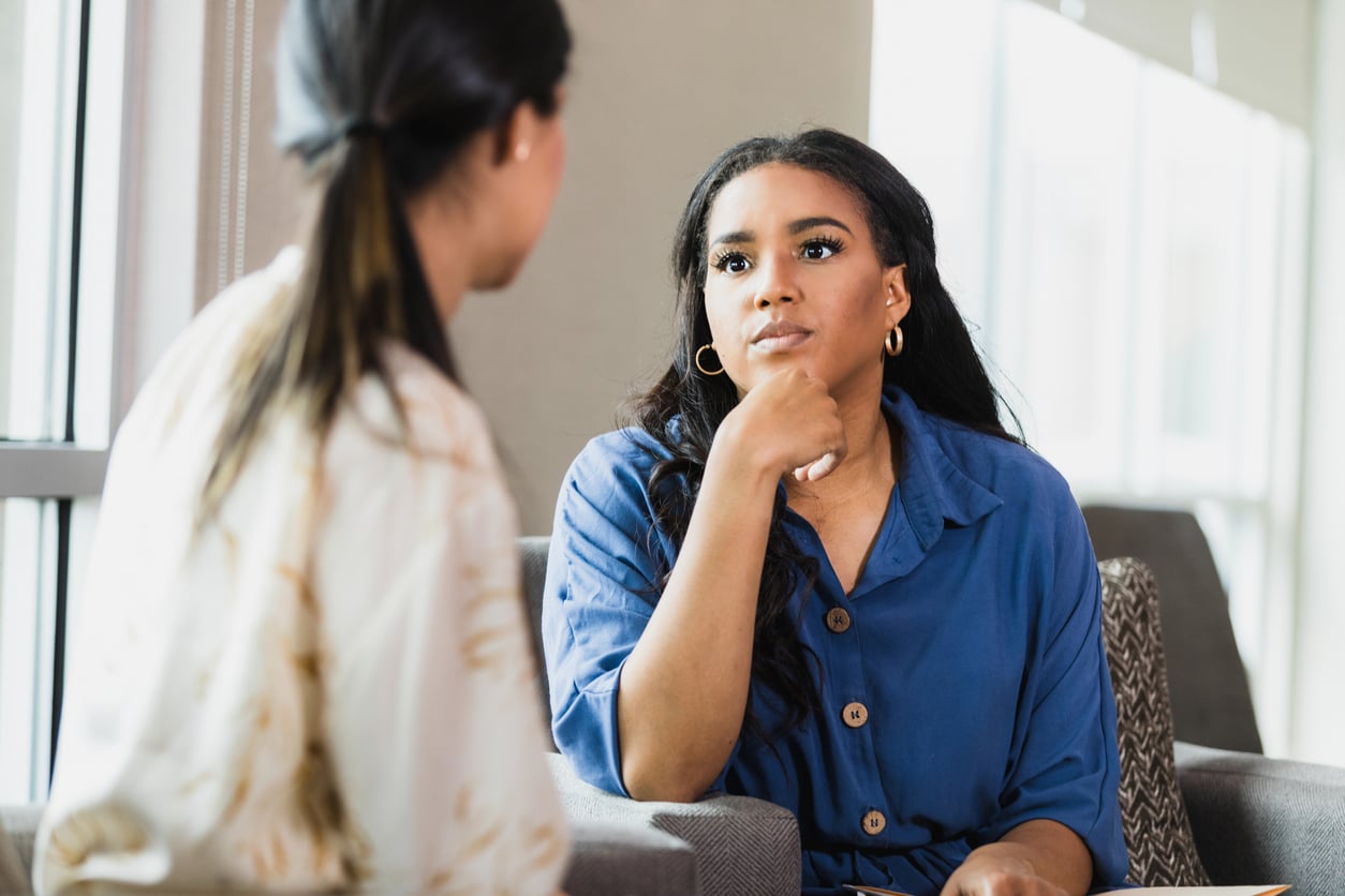 Professional woman having a private conversation about confidential addiction treatment and recovery support.