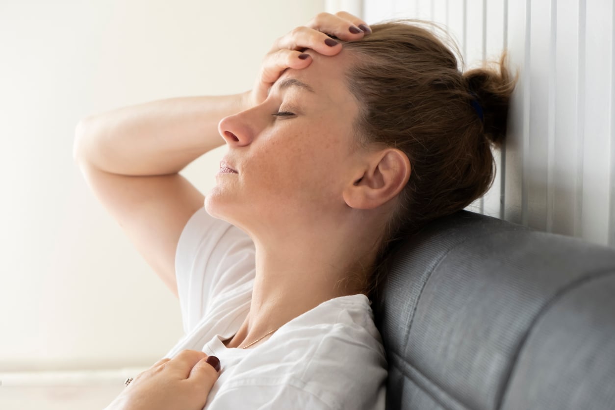 Woman resting with her eyes closed at home, illustrating emotional exhaustion associated with depression.