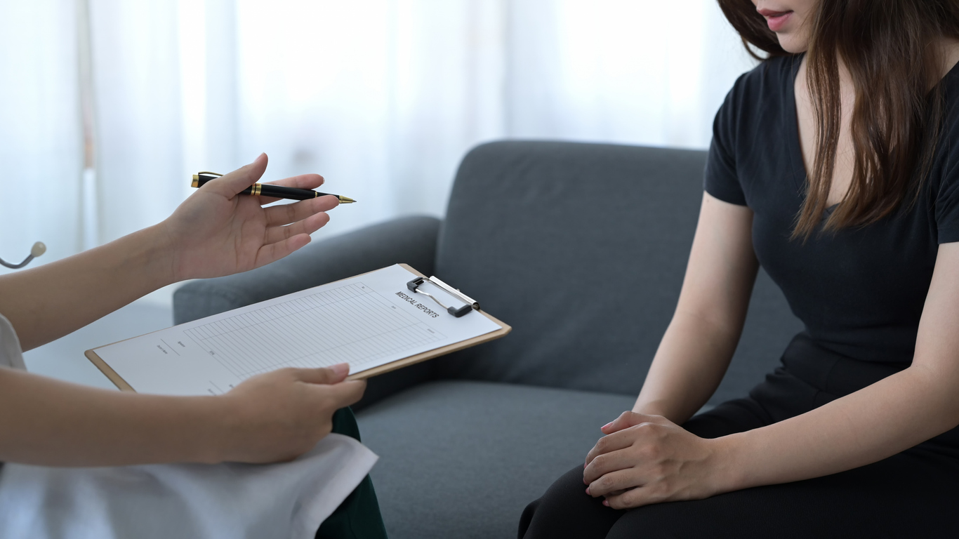 Woman meeting privately with a counselor during an individual therapy session in a partial hospitalization program.